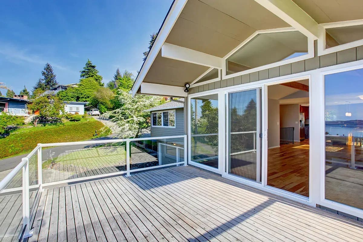 Cable railing along a deck with a hillside view